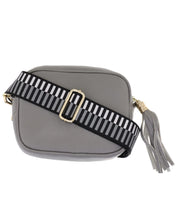 Black & grey ladder bag strap on grey leather bag